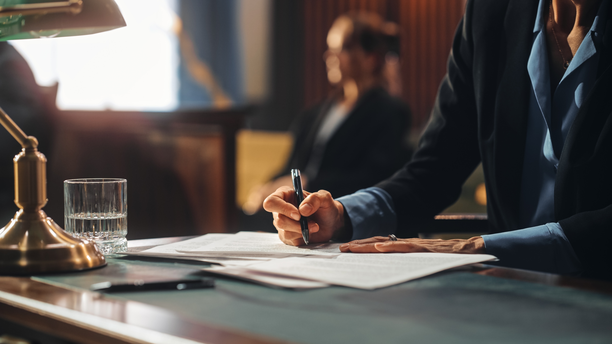 Lawyer sitting at a desk filling out paperwork